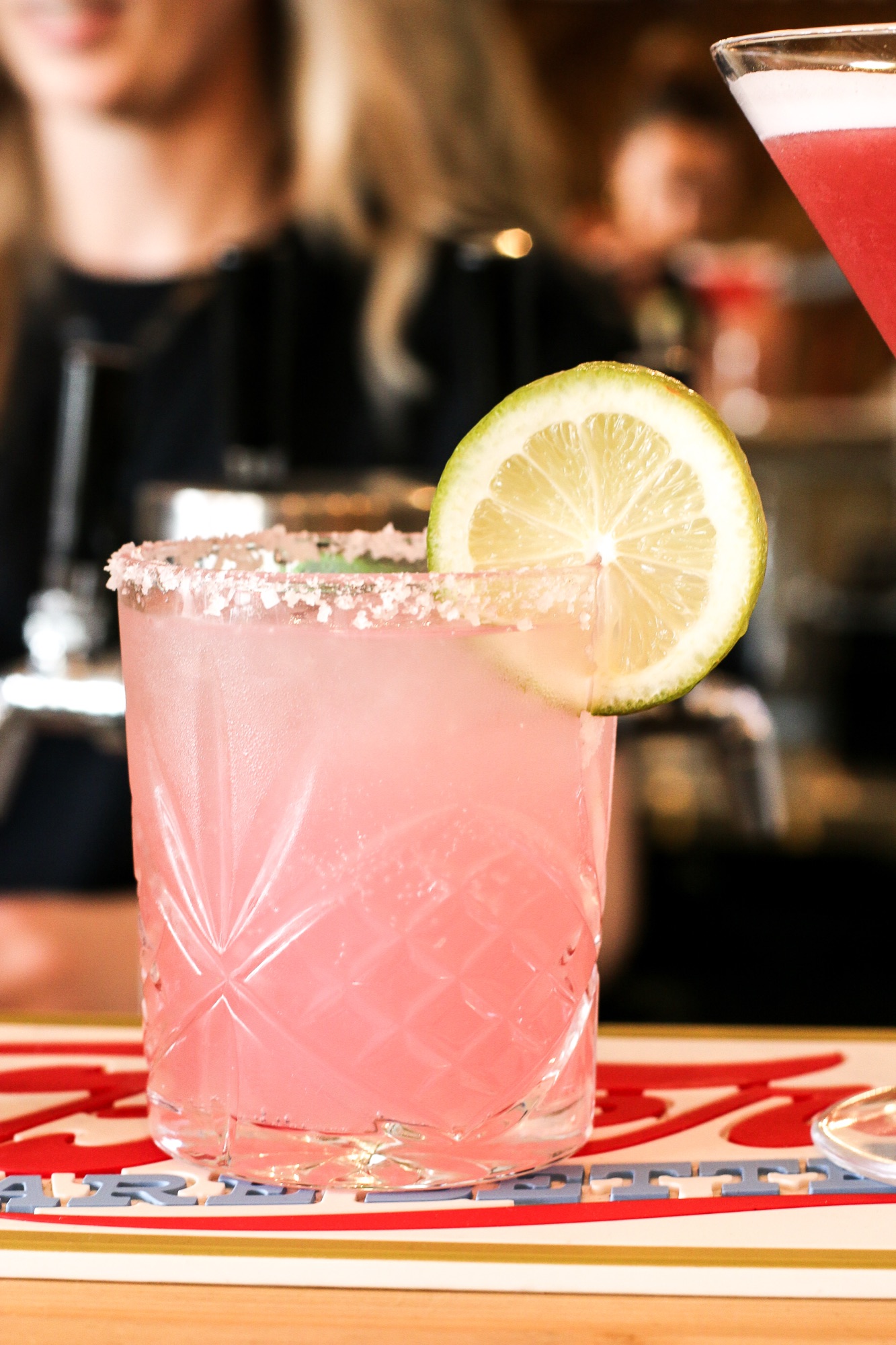 Pink cocktail with mint in a cut glass
