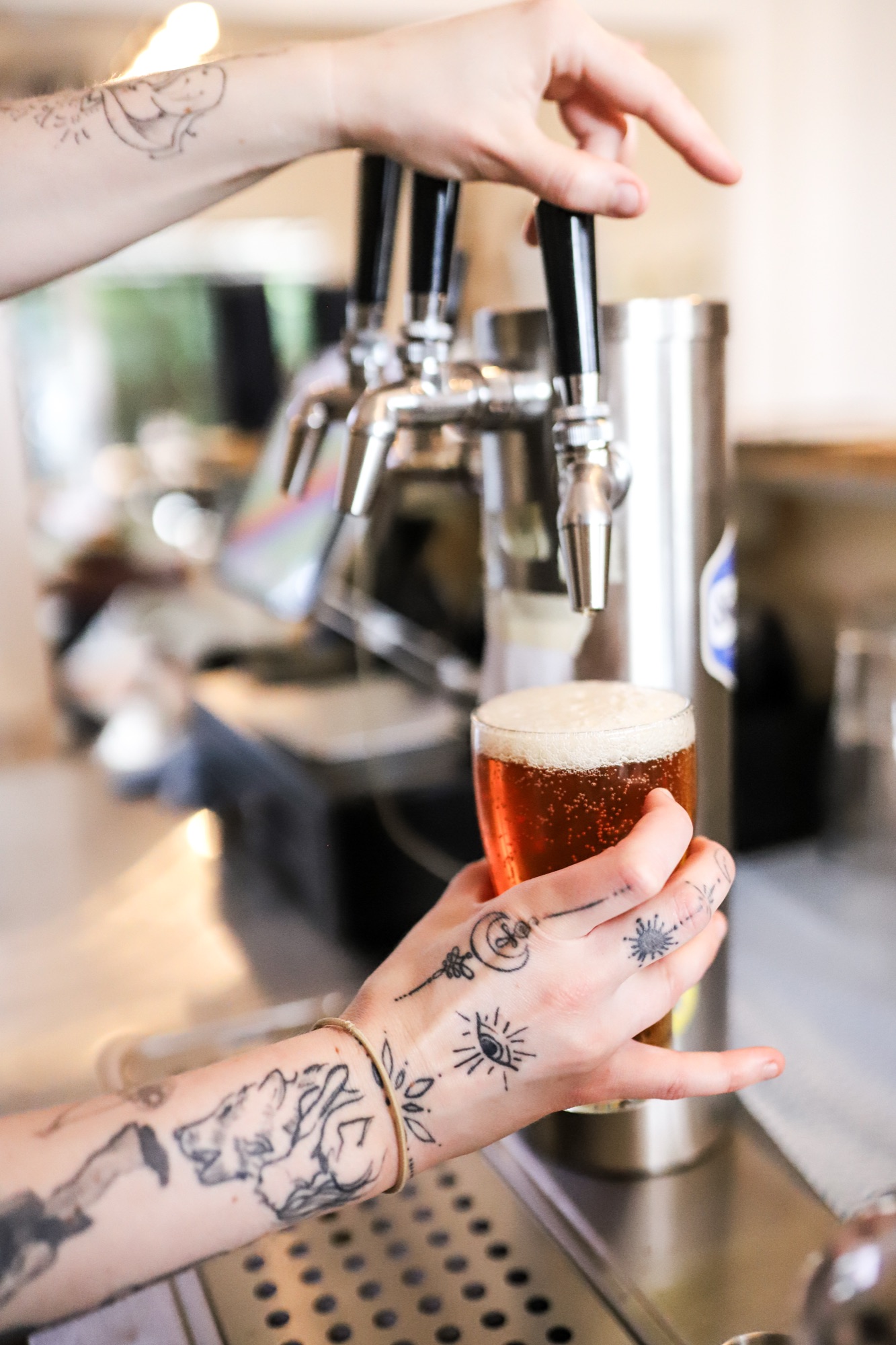 Tap pour of amber beer